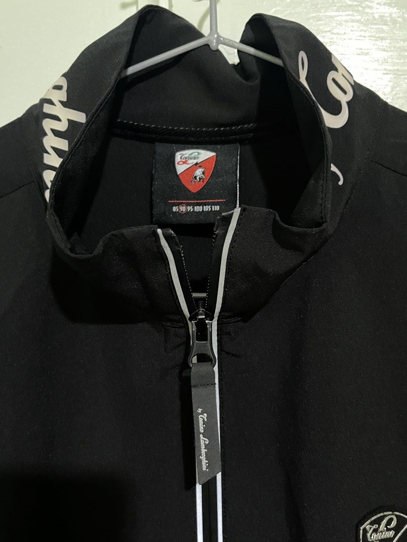 Automobili Caninos Lamborghini Track Jacket (Category: Coats, Jackets and Outerwear) located in Baguio. Submitted by azcollections_scar (Listing ID 1458354235, Image 3). Description: - Black track jacket with Lamborghini branding - Full zip front - Small embroidered logo on chest - Two side pockets - Ideal for casual wear or sports W-17.5 x L-25 Accepting good offer.