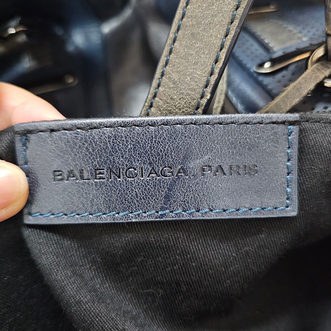 Balenciaga Paris Leather Handbag (Category: Luxury Bags & Wallets) located in Paranaque City. Submitted by ysabelsbag (Listing ID 1458477826, Image 2). Description: - Balenciaga Paris handbag - Color: Grey and Blue - Material: Leather - Hardware: Silver with buckle details - Interior: Black fabric lining - Closure: Zipper - Unique distressed finish - Ideal for everyday wear.