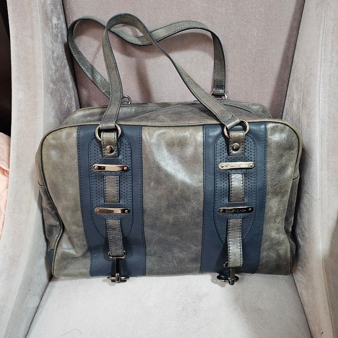 Balenciaga Paris Leather Handbag (Category: Luxury Bags & Wallets) located in Paranaque City. Submitted by ysabelsbag (Listing ID 1458477826, Image 1). Description: - Balenciaga Paris handbag - Color: Grey and Blue - Material: Leather - Hardware: Silver with buckle details - Interior: Black fabric lining - Closure: Zipper - Unique distressed finish - Ideal for everyday wear.