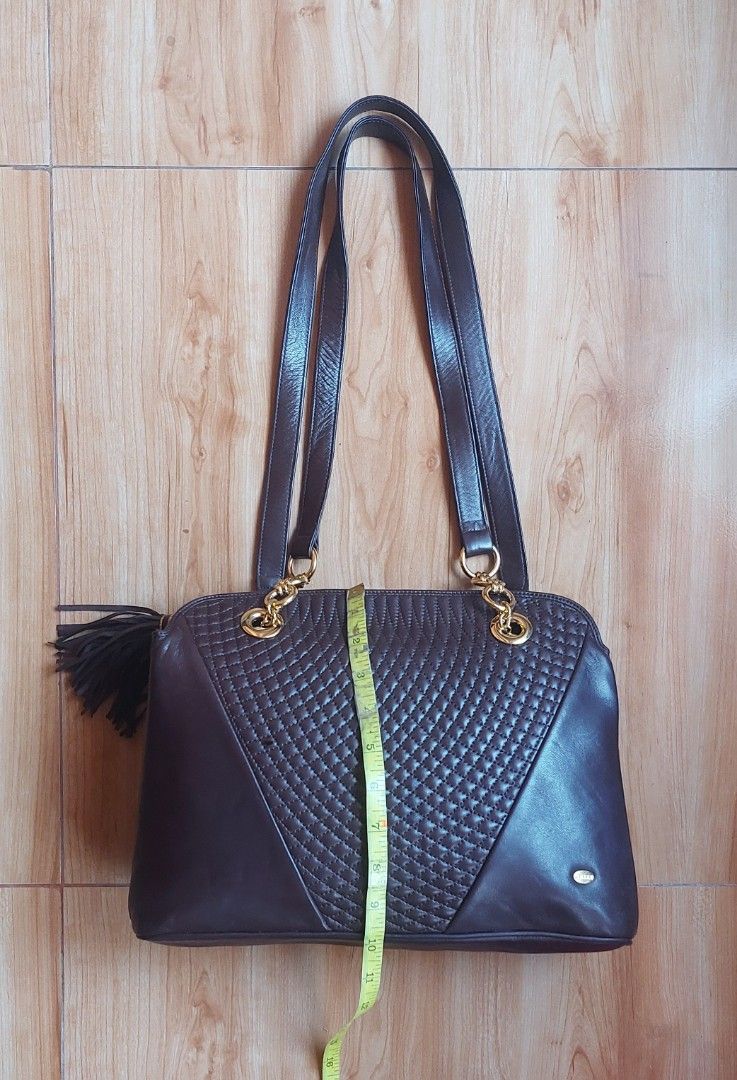 Bally Quilted Leather Shoulder Bag Dark Brown (Category: Shoulder Bags) located in Davao. Submitted by wengbagstuff (Listing ID 1458464854, Image 3). Description: ✅️ vintage in very good condition to almost new ✅️ no rubs, tear nor holes ✅️ long handles ✅️ color: choco brown ✅️ Elegant quilted pattern ✅️ Luxurious gold hardware details ✅️ Features a chic side tassel ✅️ Crafted from high-quality Lambskin leather.
