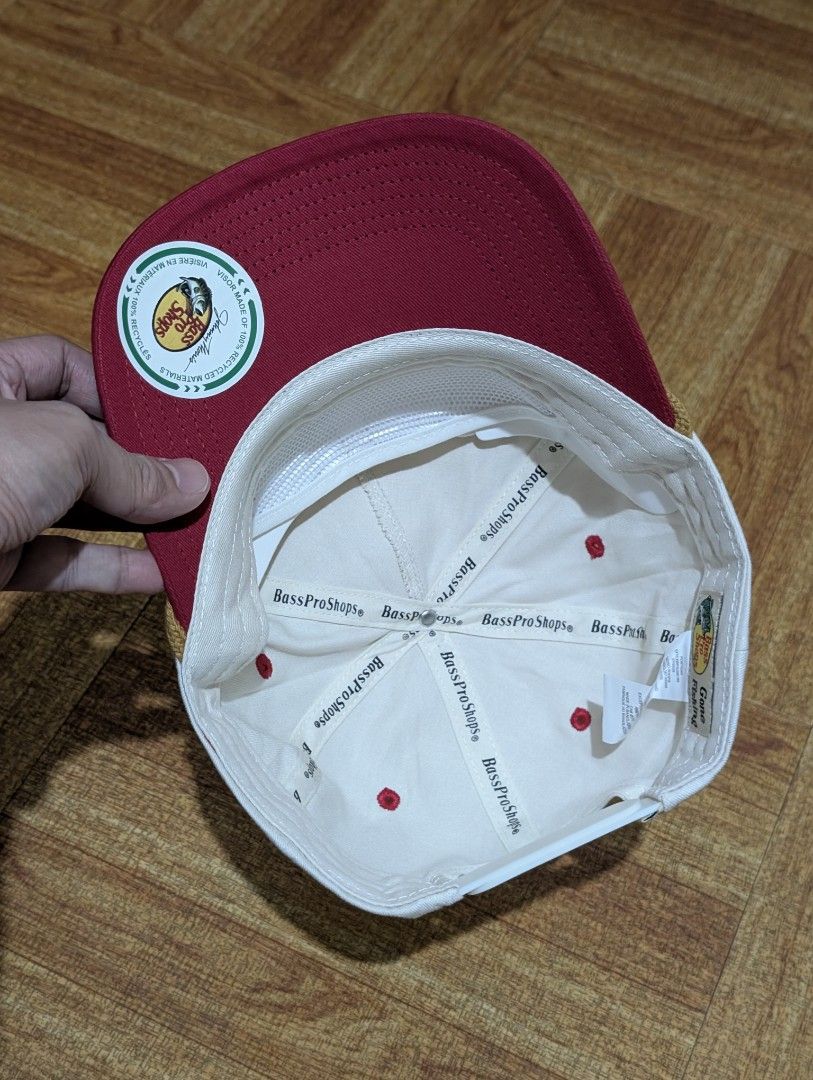 Bass Pro Shops Chenille Rope Cap (Category: Caps & Hats) located in Quezon City. Submitted by aivan_sison (Listing ID 1458449133, Image 3). Description: - White and red Bass Pro Shops cap - Features 'Bass Pro Shops EST. USA 1972' embroidery on the front - Rope detail above the brim - Adjustable strap at the back for a custom fit - Ideal for fishing trips or everyday casual wear - Issue: Minor fabric rip (see last picture).