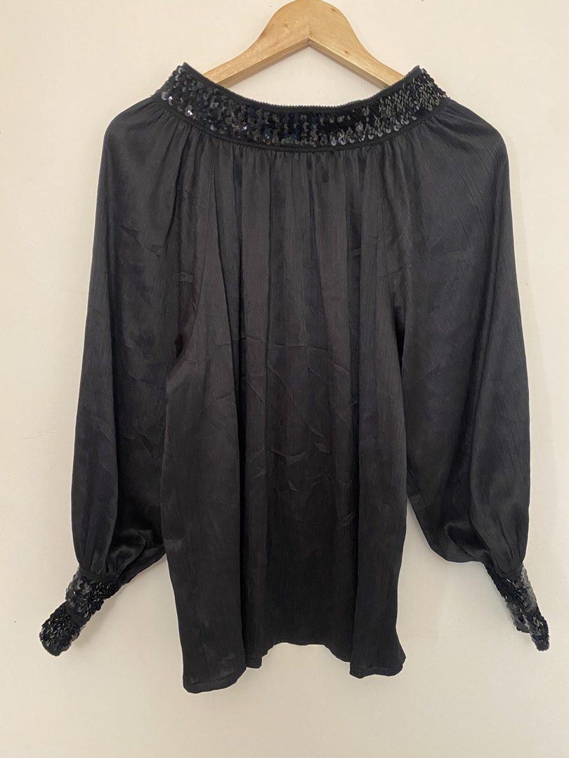Black off Shoulder Blouse with Sequins (Y2K Coquette Grunge Vintage 2000s) (Category: Blouses) located in Las Pinas. Submitted by bottega_boi (Listing ID 1458334748, Image 1). Description: - Elegant black long-sleeved blouse - Features shimmering sequins on neckline and cuffs - Subtle textured stripe fabric for added detail - Comfortable loose fit with gathered cuffs - Ideal for dressing up any outfit.