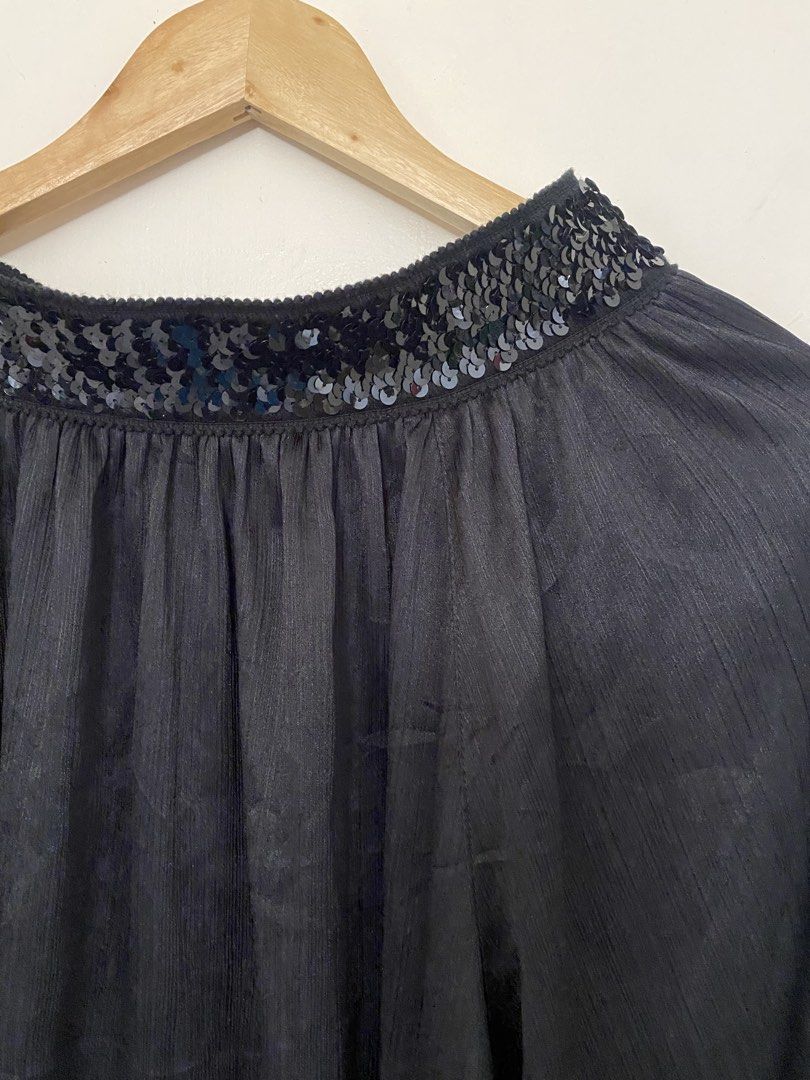 Black off Shoulder Blouse with Sequins (Y2K Coquette Grunge Vintage 2000s) (Category: Blouses) located in Las Pinas. Submitted by bottega_boi (Listing ID 1458334748, Image 2). Description: - Elegant black long-sleeved blouse - Features shimmering sequins on neckline and cuffs - Subtle textured stripe fabric for added detail - Comfortable loose fit with gathered cuffs - Ideal for dressing up any outfit.