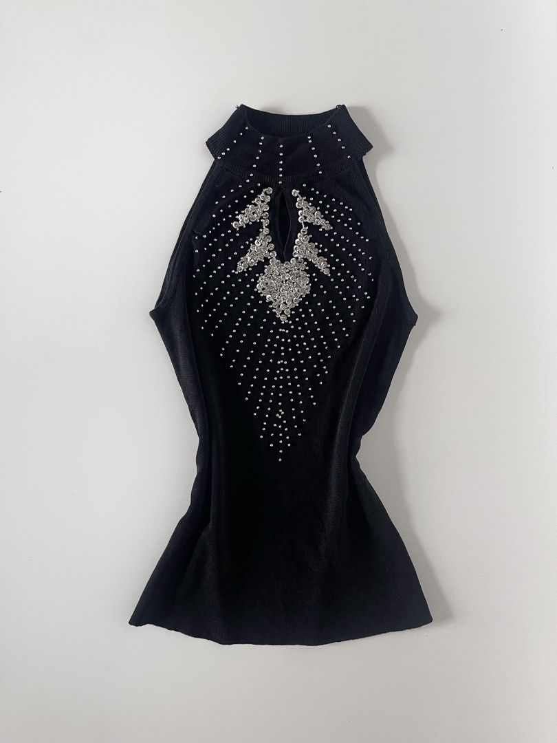 Black Sleeveless Embellished Mock Neck Top (Category: Sleeveless) located in Cavite. Submitted by devilourea (Listing ID 1458334545, Image 1). Description: - Sleeveless black top - Mock neck with chest cutout - Dazzling silver embellishments and rhinestones in a starburst pattern - Slightly flared hem - Ideal for a night out or special occasion.