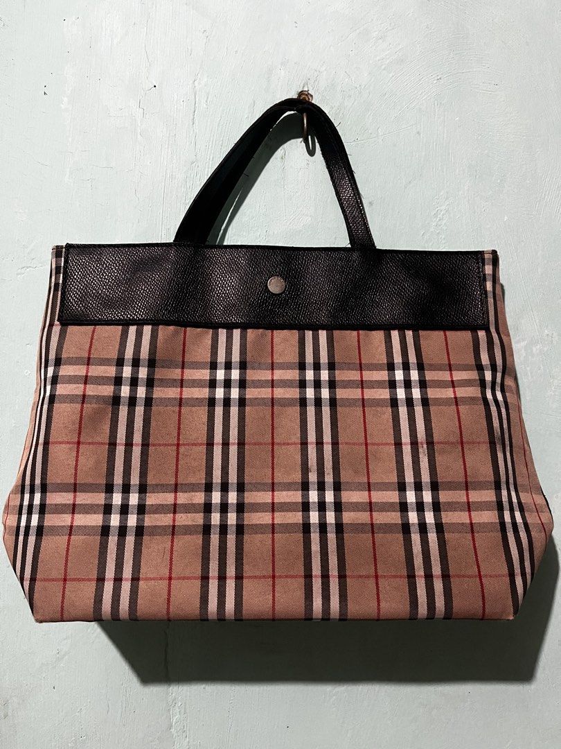 Burberry London Tote Bag (Category: Luxury Bags & Wallets) located in Manila. Submitted by shanaaa.collects (Listing ID 1458318232, Image 2). Description: - Classic Burberry tote bag - Iconic nova check pattern - Black leather trim and handles - Interior zip pocket - Snap closure for secure storage - Ideal for everyday use.