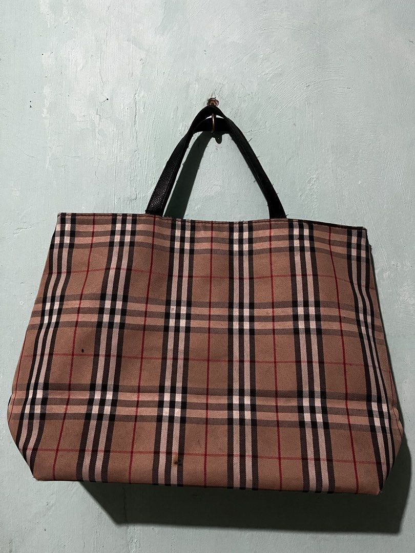 Burberry London Tote Bag (Category: Luxury Bags & Wallets) located in Manila. Submitted by shanaaa.collects (Listing ID 1458318232, Image 3). Description: - Classic Burberry tote bag - Iconic nova check pattern - Black leather trim and handles - Interior zip pocket - Snap closure for secure storage - Ideal for everyday use.