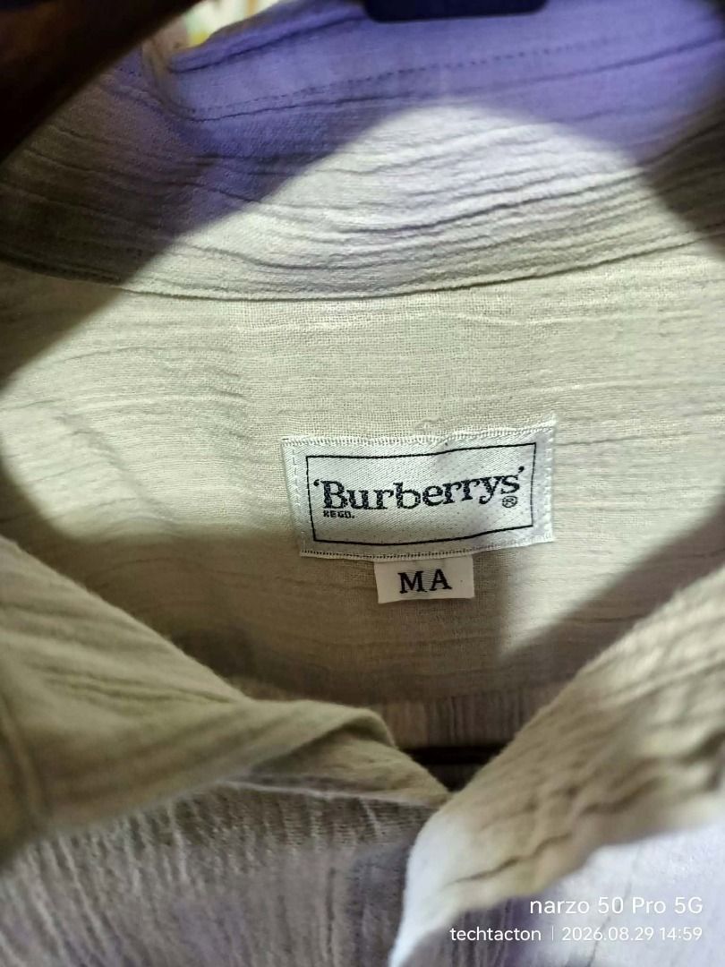Burberrys Textured button down (Category: Luxury Apparel) located in Santo Tomas. Submitted by pickers_corner (Listing ID 1458439778, Image 3). Description: vintage 90s Burbs Textured button down size MA dime 22.5x27 still in pristine condition no holes no stain - Burberrys short sleeve shirt - Size: M - Color: Light beige - Texture: Subtle stripes - Style: Classic button-up - Perfect for: Casual wear.