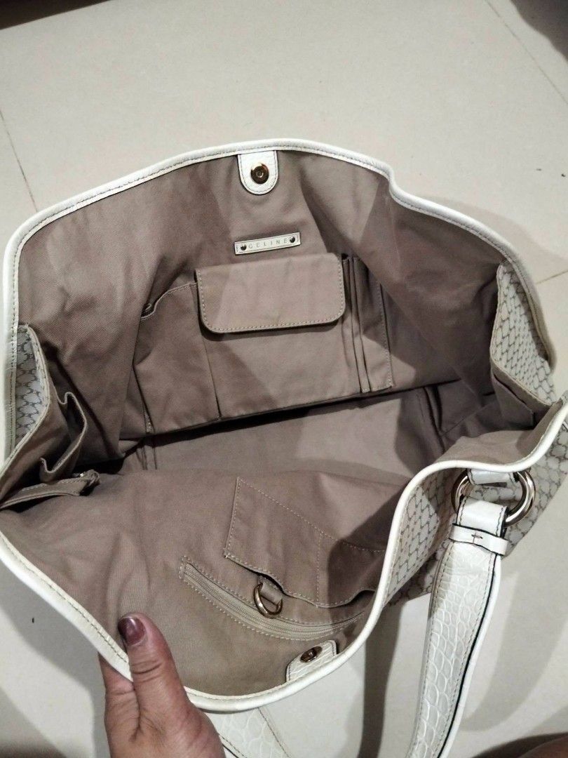 Celine macadam Monogram hobo Bag White Leather Trim (Category: Luxury Bags & Wallets) located in Manila. Submitted by ukayhuntworldwide (Listing ID 1458311741, Image 2). Description: - Authentic Celine macadam - White leather trim with embossed pattern - Multiple interior pockets - Interior zip compartment - Gold hardware details - Drawstring closure - Ideal for everyday use.