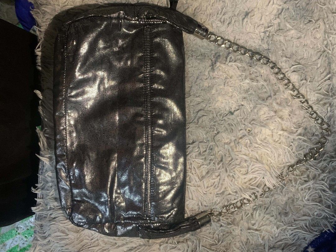Chanel Black Metallic Clutch Chain Bag (Category: Luxury Bags & Wallets) located in Manila. Submitted by youngturtle.8e129a (Listing ID 1458345438, Image 3). Description: - Sleek black metallic clutch - Iconic embossed CC logo on the front - Detachable chain strap for versatile wear - Interior zippered pocket for essentials - Lined with classic Chanel logo pattern - Authentically Made in France - A sophisticated accessory for any occasion.