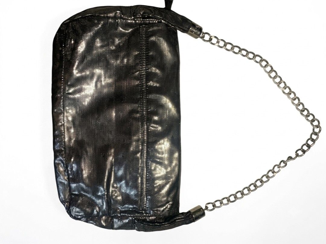 Chanel Black Metallic Clutch Chain Bag (Category: Luxury Bags & Wallets) located in Manila. Submitted by youngturtle.8e129a (Listing ID 1458345438, Image 2). Description: - Sleek black metallic clutch - Iconic embossed CC logo on the front - Detachable chain strap for versatile wear - Interior zippered pocket for essentials - Lined with classic Chanel logo pattern - Authentically Made in France - A sophisticated accessory for any occasion.