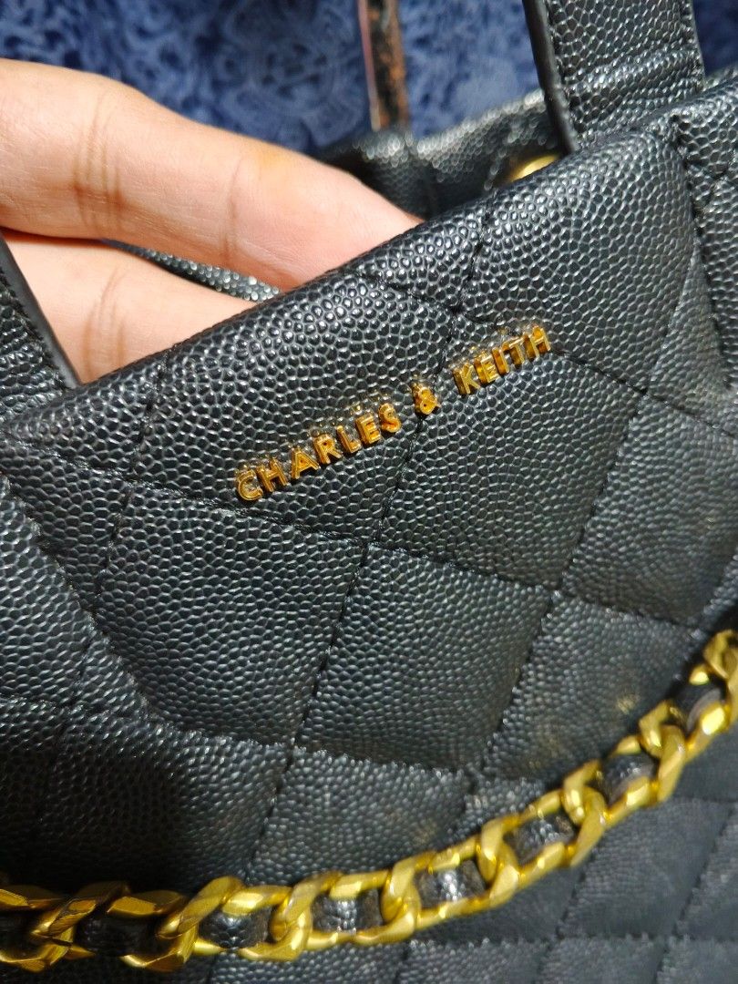 Charles & Keith Black Quilted Leather Handbag (Category: Luxury Bags & Wallets) located in Bulacan. Submitted by dn_thrifted (Listing ID 1458388443, Image 2). Description: - Authentic Black 3 way CHARLES & KEITH TOTE / Handbag - Quilted Leather with CHARLES AND KIT LOGO - Top Handle and Detachable Shoulder Strap - Medium Size - Versatile for Daily Use or Nights Out - Clean Interior.