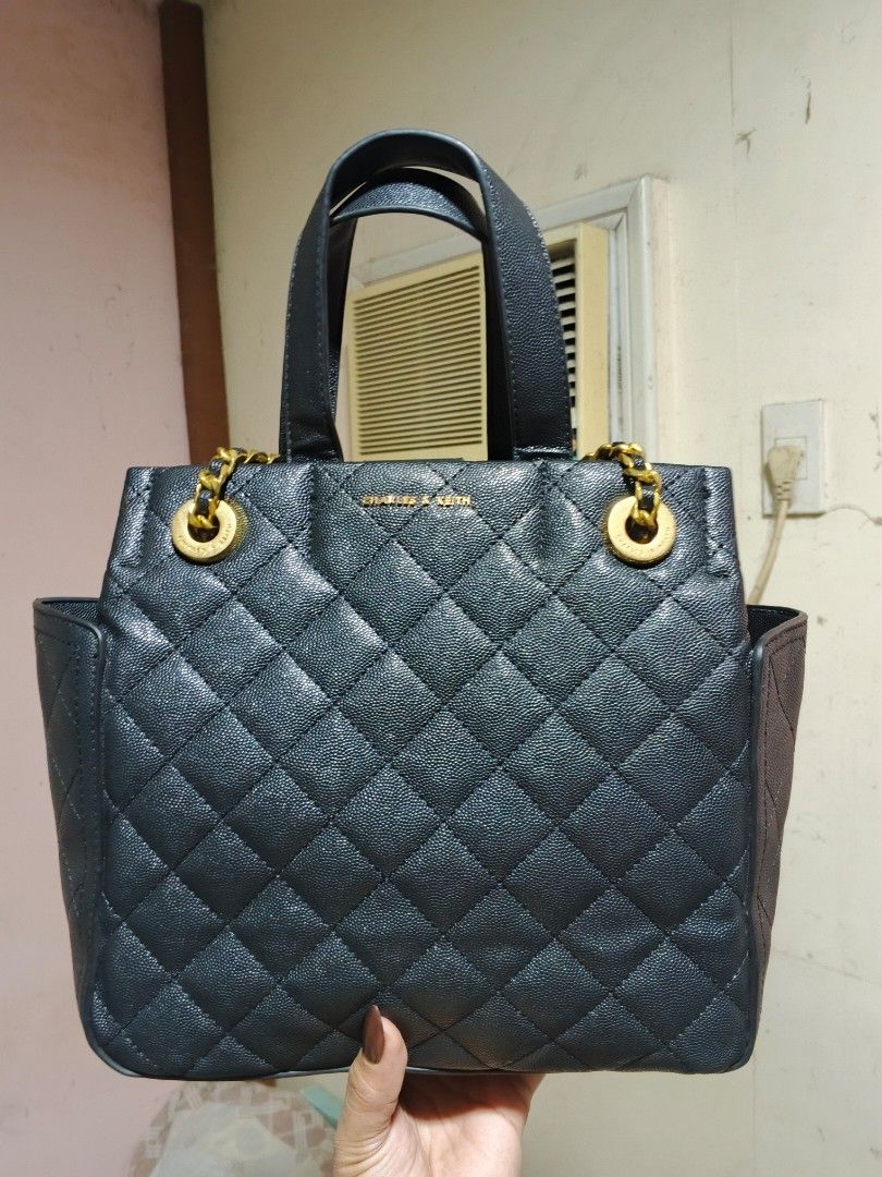 Charles & Keith Black Quilted Leather Handbag (Category: Luxury Bags & Wallets) located in Bulacan. Submitted by dn_thrifted (Listing ID 1458388443, Image 1). Description: - Authentic Black 3 way CHARLES & KEITH TOTE / Handbag - Quilted Leather with CHARLES AND KIT LOGO - Top Handle and Detachable Shoulder Strap - Medium Size - Versatile for Daily Use or Nights Out - Clean Interior.