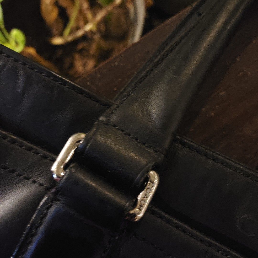 Coach Black Leather Briefcase (Category: Briefcases) located in Taguig. Submitted by panicxitsxjim (Listing ID 1458315907, Image 2). Description: - Brand: Coach - Color: Black - Material: Leather - Features: Top handles, detachable shoulder strap - Interior: Spacious, clean - Condition: Good, with some signs of wear on the leather - Ready for its next owner.