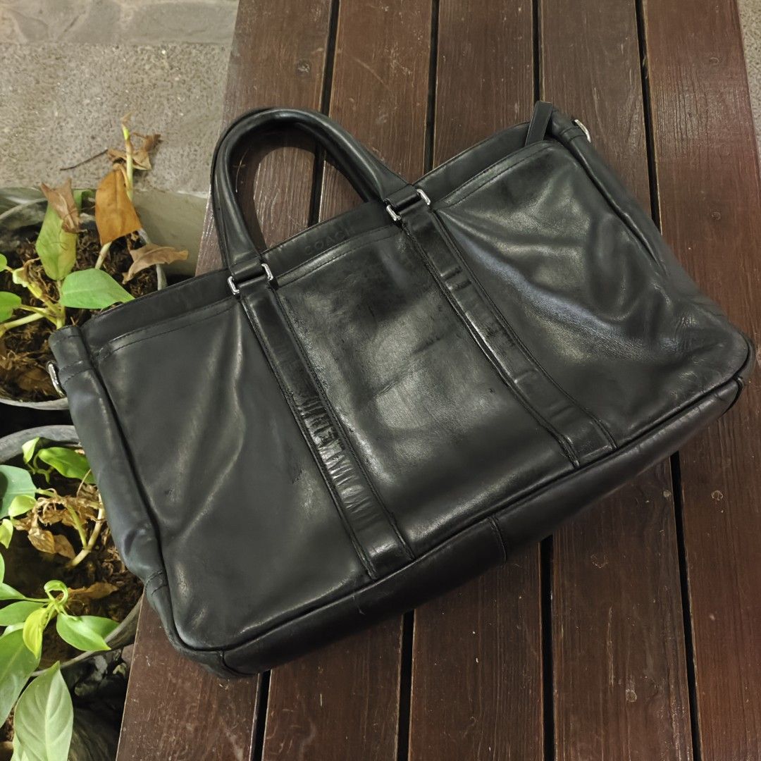 Coach Black Leather Briefcase (Category: Briefcases) located in Taguig. Submitted by panicxitsxjim (Listing ID 1458315907, Image 3). Description: - Brand: Coach - Color: Black - Material: Leather - Features: Top handles, detachable shoulder strap - Interior: Spacious, clean - Condition: Good, with some signs of wear on the leather - Ready for its next owner.