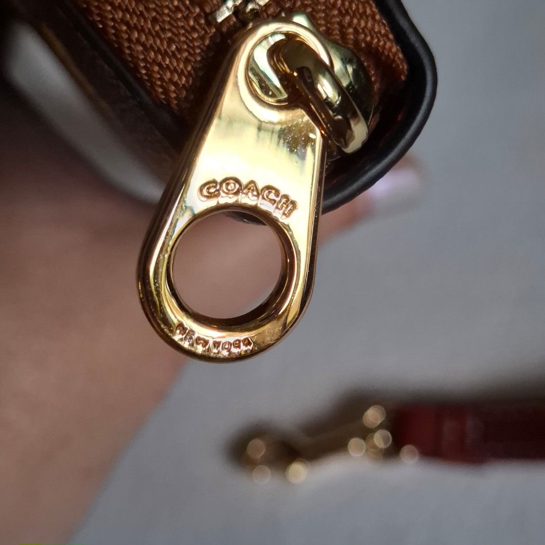 Coach x Peanuts Snoopy Zip Around Wallet (Category: Wallets & Card holders) located in Don Carlos. Submitted by PphiXi_Finds (Listing ID 1458357659, Image 3). Description: - Coach x Peanuts collaboration wallet - Features classic Coach monogram with Snoopy and Woodstock graphics - Secure zip-around closure - Detachable wrist strap included - Multiple card slots and compartments for organization - Comes with original dust bag and shopping bags.