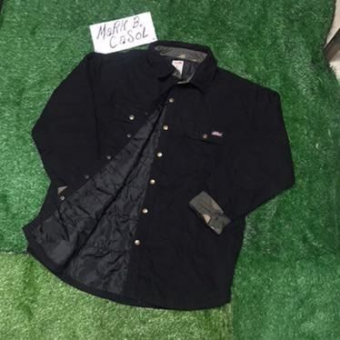 Dickies Black Quilted Lined Work Shirt Jacket (Category: Coats, Jackets and Outerwear) located in Taytay. Submitted by markcasol45 (Listing ID 1458371223, Image 1). Description: - Dickies black work shirt jacket - Quilted lining for extra warmth - Camo print on inside collar and cuffs - Button-up front with chest pockets - Durable material - Perfect for layering or wearing alone - Ready for its next owner.