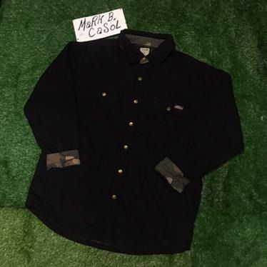 Dickies Black Quilted Lined Work Shirt Jacket (Category: Coats, Jackets and Outerwear) located in Taytay. Submitted by markcasol45 (Listing ID 1458371223, Image 2). Description: - Dickies black work shirt jacket - Quilted lining for extra warmth - Camo print on inside collar and cuffs - Button-up front with chest pockets - Durable material - Perfect for layering or wearing alone - Ready for its next owner.