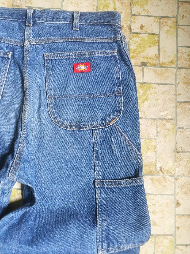 Dickies Carpenter Jeans 34x32 Blue Denim (Category: Jeans) located in Santo Tomas. Submitted by ven_thrift (Listing ID 1458300701, Image 3). Description: - Classic Dickies Carpenter Jeans - Size: 34 Waist x 32 Inseam - Color: Blue Denim - Material: 100% Cotton - Features: Iconic red Dickies logo patch, multiple functional pockets - Origin: Made in Mexico - Style: Durable and versatile for work or casual wear.