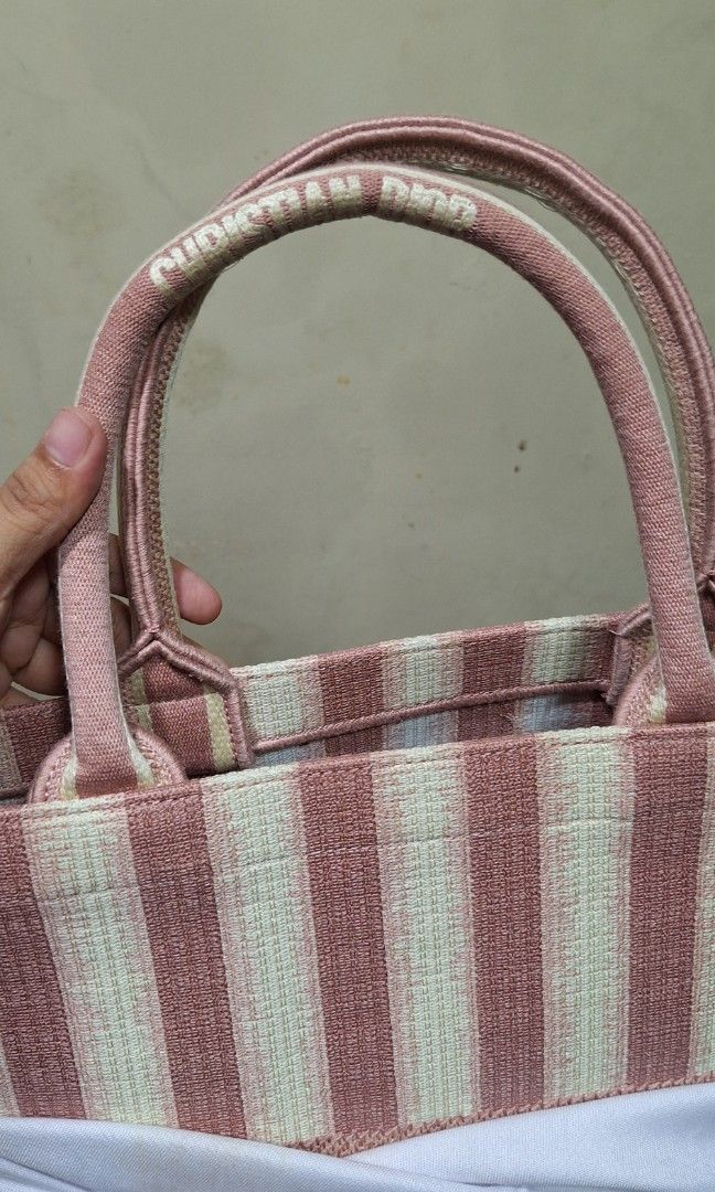 Dior book tote (Category: Luxury Bags & Wallets) located in Quezon City. Submitted by little.tinderella (Listing ID 1458363194, Image 2). Description: Personal preloved po ito, pero still NGA, please self authenticate pa rin po. Need linisan lang po ito with its dustbag po..
