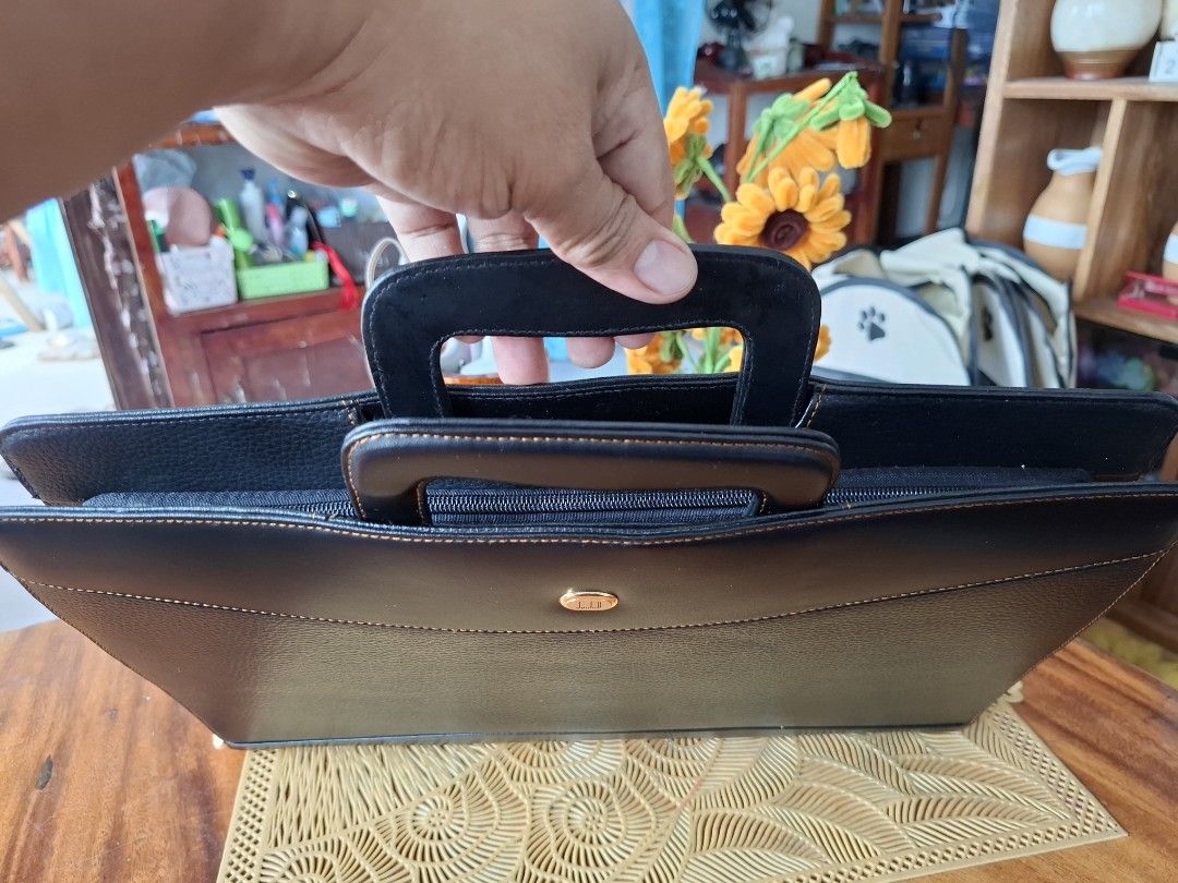 DUNHILL Black Leather Briefcase (Category: Luxury Bags & Wallets) located in Libon. Submitted by jaladzarmi80045 (Listing ID 1458350687, Image 3). Description: -not used-super excellent condition (look at the zipper still in the middle) - Classic black leather briefcase -convertible to clutchbag - Zippered compartment on the back - Multiple interior pockets for organization - Sturdy and comfortable handles - Ideal for work or travel -size: 10.5"×