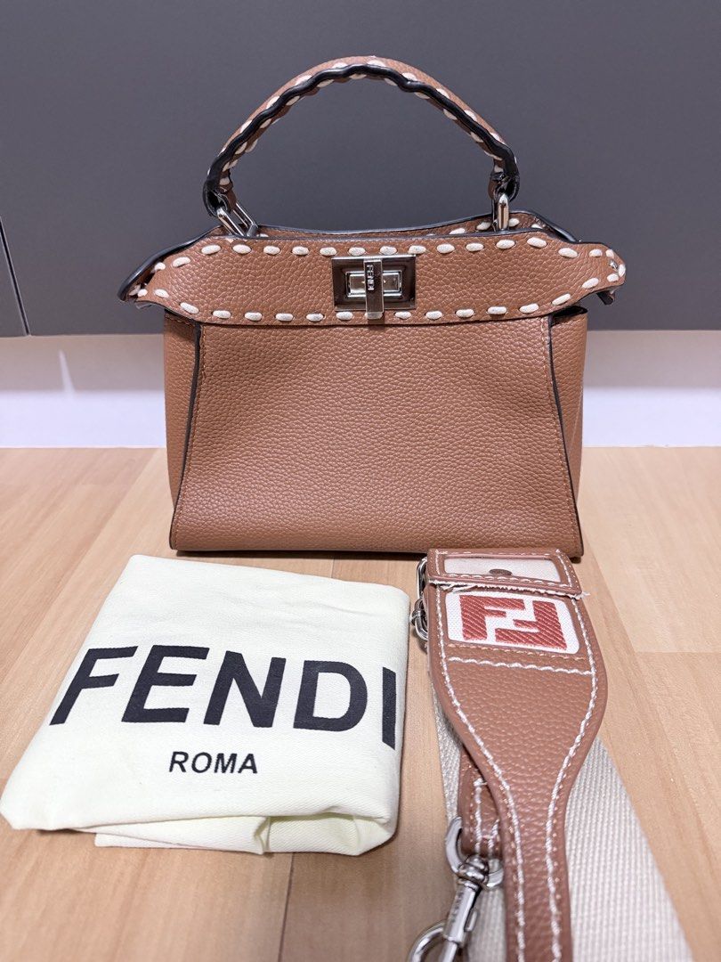 Fendi Peekaboo Bag (Category: Luxury Bags & Wallets) located in Manila. Submitted by heypreloved2016 (Listing ID 1458397351, Image 1). Description: Brown Fendi Peekaboo bag. Textured leather with white stitching detail. Silver hardware and clasp closure. Top handle and detachable shoulder strap. Includes Fendi dust bag. Great for everyday use. .