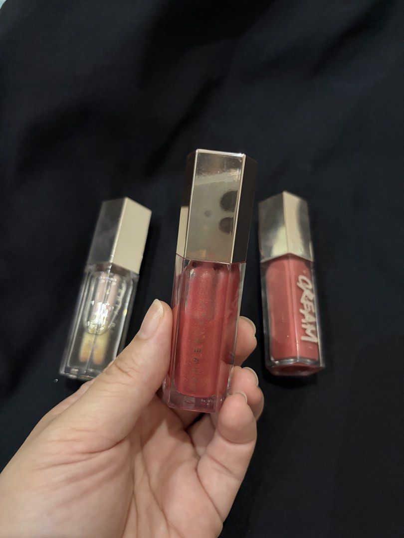 Fenty Beauty Glosses (Category: Makeup) located in Quezon City. Submitted by christyl1997 (Listing ID 1458379591, Image 2). Description: - 300php EACH - get all for 800 - the lid of Cream gloss has crack :( - shades: Gloss Bomb in Pink Dragonfly, Gloss Bomb Cream in Fenty Glow, Gloss Bomb in Glass Slipper - no box.
