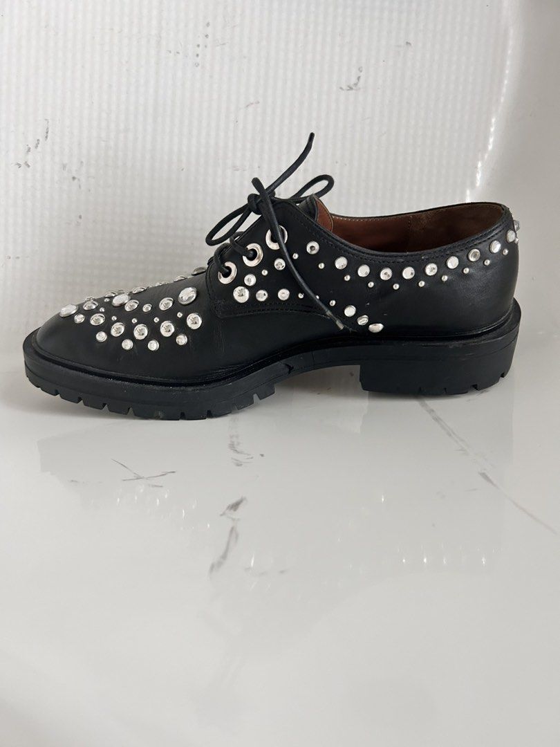 Givenchy Paris Black Leather Studded Derby Shoes (Category: Sneakers & Footwear) located in Cainta. Submitted by kmkmkm19 (Listing ID 1458387913, Image 3). Description: - Brand: Givenchy Paris - Size: 39 - Model Name: Givenchy Studded & Crystal Embellished Lug Sole Leather Derby Shoes - Style: Black Leather Derby Shoes - Embellishments: All-over silver-tone studs and crystals - Sole: Chunky with lugged outsole - Closure: Lace-up front .