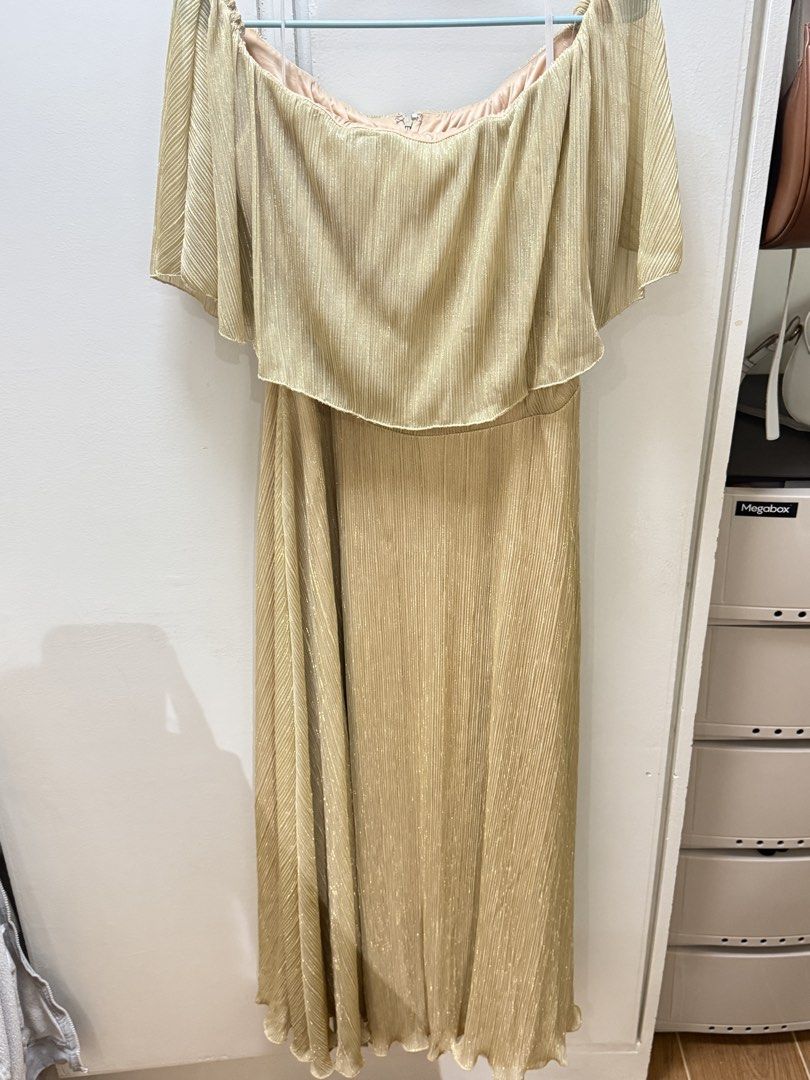 Gold Off-Shoulder Pleated Maxi Dress (Category: Dresses) located in Manila. Submitted by aly_rys (Listing ID 1458413786, Image 1). Description: READ DESCRIPTION ❣️ RFS: Decluttering, will migrate soon. SRP: 1900 from SM Dept Store Price still negotiable :) - Used for only one time in a church event - Beautiful gold maxi dress - Elegant off-shoulder design - Flowy cape overlay - Shimmery pleated fabric - Convenient back zipper closure - Ideal for 