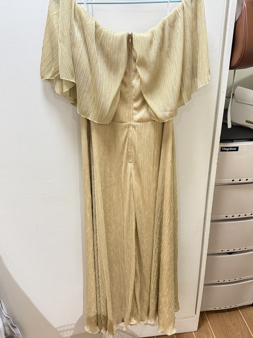 Gold Off-Shoulder Pleated Maxi Dress (Category: Dresses) located in Manila. Submitted by aly_rys (Listing ID 1458413786, Image 2). Description: READ DESCRIPTION ❣️ RFS: Decluttering, will migrate soon. SRP: 1900 from SM Dept Store Price still negotiable :) - Used for only one time in a church event - Beautiful gold maxi dress - Elegant off-shoulder design - Flowy cape overlay - Shimmery pleated fabric - Convenient back zipper closure - Ideal for 