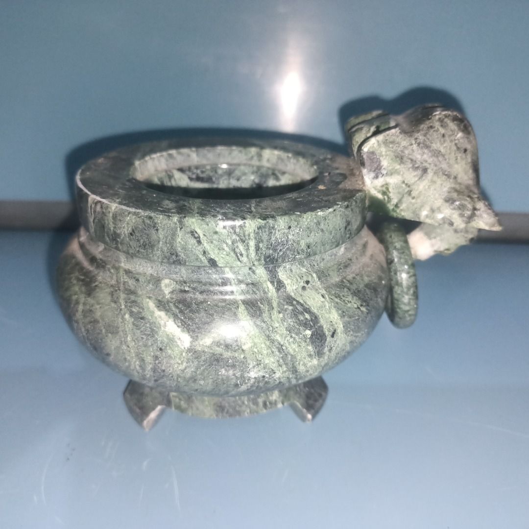 Green Marble Incense burner (Category: Pots & Planters) located in Munoz. Submitted by larryc1212 (Listing ID 1458436430, Image 1). Description: - Elegant green marble incense burner with beautiful veined patterns. - Features a convenient handle on one side. - Stands sturdily on three decorative legs. - Ideal for displaying as a decorative accent or housing small plants. - Compact size: approximately 4 inches in height. - With Issue Disclaimer: I