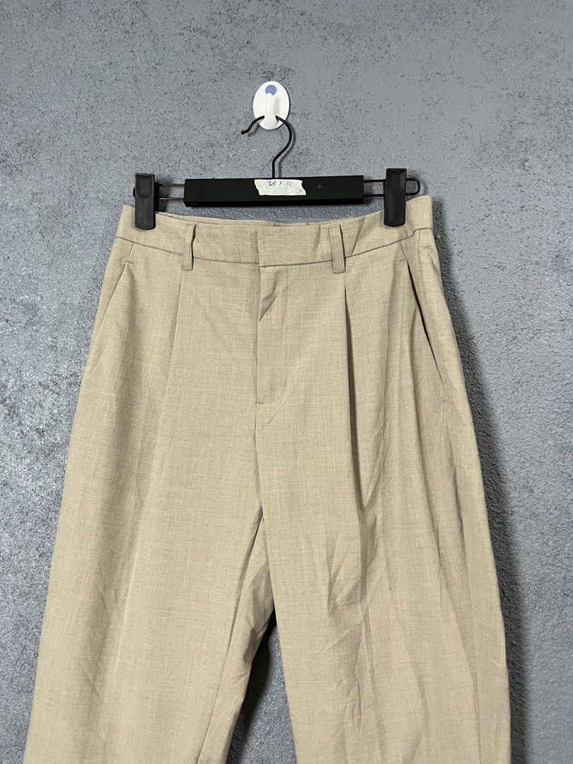 GU Beige Pleated Trousers Size S (Category: Other Bottoms) located in Famy. Submitted by basicthrifted (Listing ID 1458443784, Image 2). Description: - Brand: GU - Color: Beige - Size: S - Fit: Relaxed - Style: Classic, pleated - Material: Polyester, Rayon, Polyurethane blend (check tag for exact composition) - Versatile: Easy to pair with various tops for casual or smart-casual outfits.