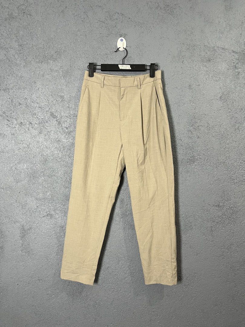 GU Beige Pleated Trousers Size S (Category: Other Bottoms) located in Famy. Submitted by basicthrifted (Listing ID 1458443784, Image 1). Description: - Brand: GU - Color: Beige - Size: S - Fit: Relaxed - Style: Classic, pleated - Material: Polyester, Rayon, Polyurethane blend (check tag for exact composition) - Versatile: Easy to pair with various tops for casual or smart-casual outfits.