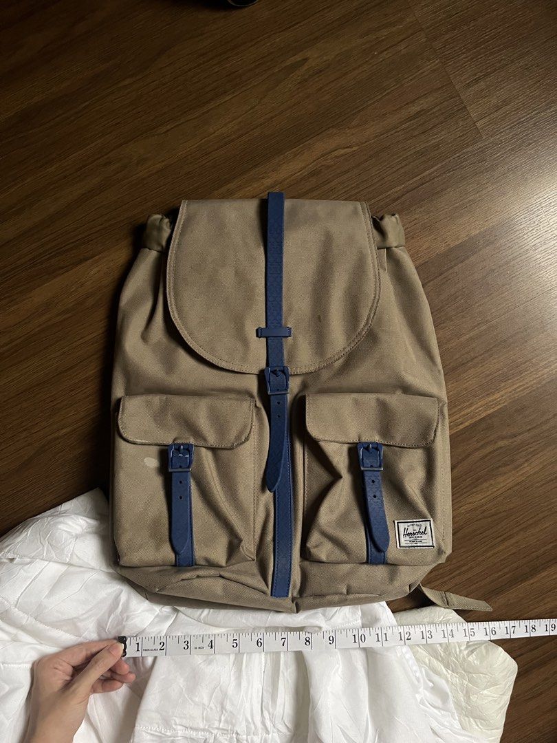 Herschel Supply Co. Backpack Tan Blue Straps (Category: Backpacks) located in Quezon City. Submitted by hellopucca (Listing ID 1458472832, Image 1). Description: - Classic Herschel backpack in tan - Features blue strap details and buckle closures - Two front pockets with buckle closures - Padded shoulder straps for comfort - Ideal for school or everyday use - Approximately 17 inches tall.