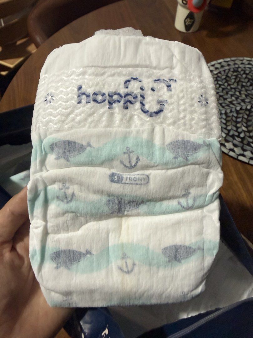 Hoppi Luxury Tape Diapers Size S (Category: Diapers & Baby Wipes) located in Mandaluyong City. Submitted by lulubelle86 (Listing ID 1458425414, Image 2). Description: - Hoppi Tape Diapers - Size: S - Weight Range: 0-5kg - Features: Cloud touch softness, up to 12 hours absorbency - Quantity: 23 diapers Millie Moon bag only. Hoppi diapers inside. Rfs: too small for baby.