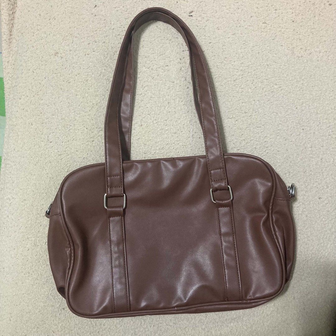 japanese brown leather school bag (Category: Shoulder Bags) located in Pasig City. Submitted by pollyyesterr (Listing ID 1458452076, Image 2). Description: jp brown leather school bag fits 11” ipad - has minor flaws (holes from pins) lagyan niyo nalang ng pins to hide ^^ - has some stains (?) i think removable siya, pero unnoticable - zipper is matibayy.