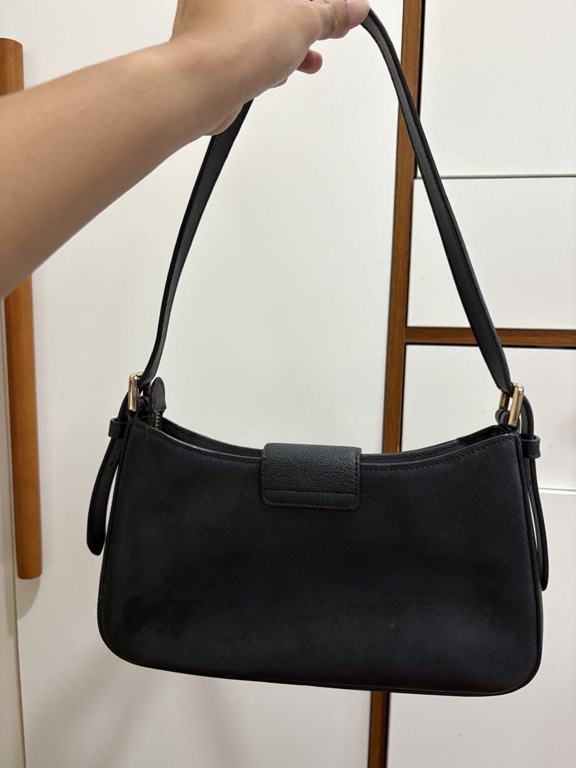 Kate Spade Black Leather Shoulder Bag (Category: Luxury Bags & Wallets) located in Manila. Submitted by pristineclosetph (Listing ID 1458354057, Image 2). Description: - Classic black shoulder bag by Kate Spade New York - Crafted from textured leather - Elegant gold-tone buckle closure on front flap - Adjustable shoulder strap with buckle - Secure top zipper closure - Ideal for everyday use.
