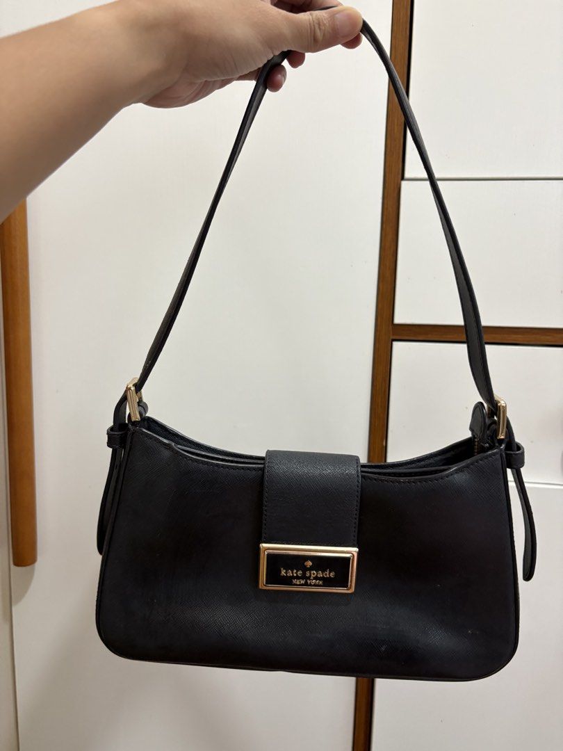 Kate Spade Black Leather Shoulder Bag (Category: Luxury Bags & Wallets) located in Manila. Submitted by pristineclosetph (Listing ID 1458354057, Image 1). Description: - Classic black shoulder bag by Kate Spade New York - Crafted from textured leather - Elegant gold-tone buckle closure on front flap - Adjustable shoulder strap with buckle - Secure top zipper closure - Ideal for everyday use.