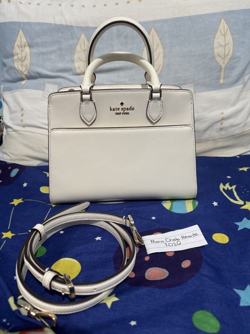 Kate Spade Madison Small Satchel Bag (Category: Luxury Bags & Wallets) located in Tanza. Submitted by chi_0826 (Listing ID 1458362762, Image 1). Description: 3,200 + SF Authentic Kate Spade NY cream saffiano leather satchel and crossbody bag - Champagne gold hardwares - Versatile with top handle and detachable crossbody strap - Convenient front pocket for quick access - Secure zipper closure - Clean and spacious interior - Ideal for both daily er