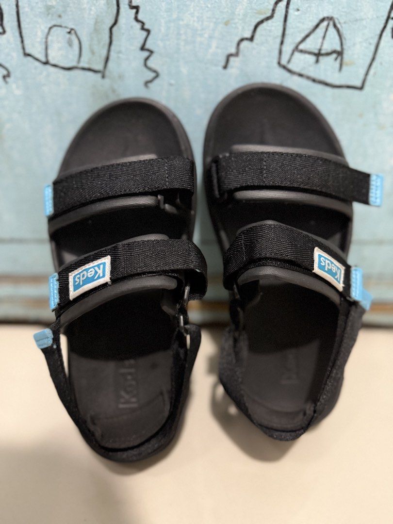 Keds Sandals (Category: Flats & Sandals) located in Valenzuela. Submitted by boutiquechic (Listing ID 1458344028, Image 1). Description: - Black Keds sport sandals - Adjustable velcro straps with blue accent tab - Keds logo on footbed - Comfortable and practical for everyday wear - Great for walks or casual outings.
