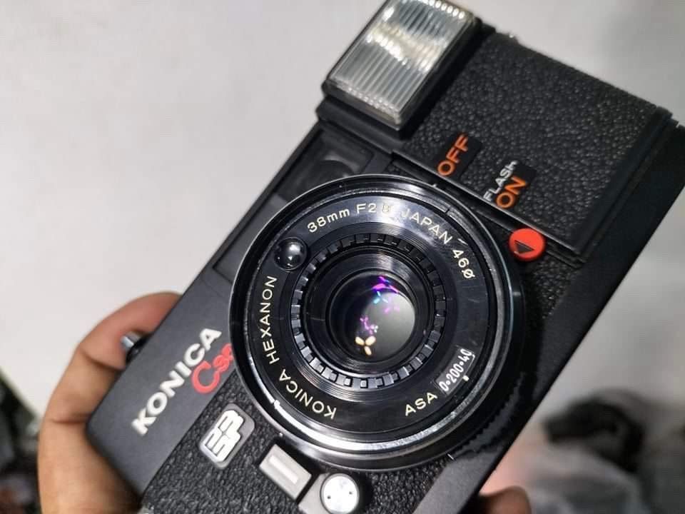 Konica C35 EF 35mm Film Camera (Category: Cameras) located in Mandaluyong City. Submitted by chiacells (Listing ID 1458444472, Image 2). Description: - Classic Konica C35 EF point-and-shoot film camera - Features a sharp 38mm F2.8 Hexanon lens - Built-in flash with ON/OFF switch for convenience - Compact and incredibly easy to use, ideal for beginners - Great for capturing everyday moments on film - Serial number 423600 visible.