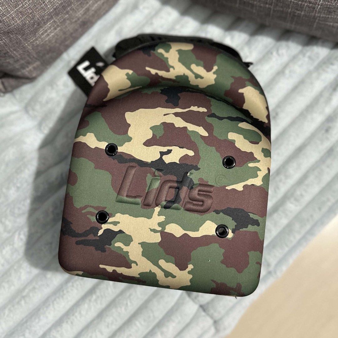 Lids Camo Cap Carrier Case (Category: Caps & Hats) located in Agdangan. Submitted by kiiiiingg (Listing ID 1458329763, Image 1). Description: - Protect your caps with this Lids camo cap carrier. - Holds multiple hats. - Zipper closure for secure storage. - Made of durable material. - Ideal for travel or home storage. - Keeps your caps in their original shape..
