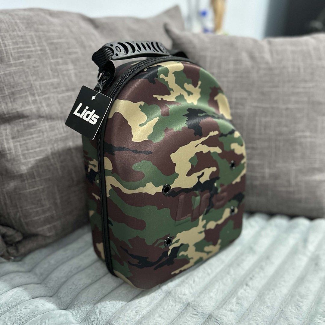 Lids Camo Cap Carrier Case (Category: Caps & Hats) located in Agdangan. Submitted by kiiiiingg (Listing ID 1458329763, Image 3). Description: - Protect your caps with this Lids camo cap carrier. - Holds multiple hats. - Zipper closure for secure storage. - Made of durable material. - Ideal for travel or home storage. - Keeps your caps in their original shape..