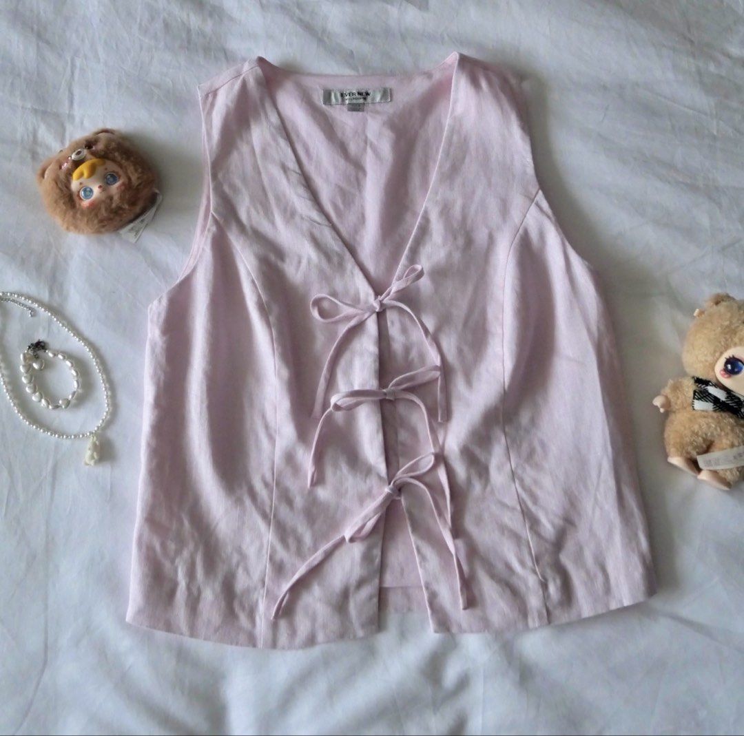 Light Pink V-Neck Vest with Tie Front (Category: Sleeveless) located in Manila. Submitted by preloved.shan1a (Listing ID 1458429847, Image 1). Description: - Fits Semi Med -Cute light pink vest - V-neckline with front tie-up detail - Sleeveless design - Ideal for layering or wearing on its own - Easily styled for casual or dressy looks.