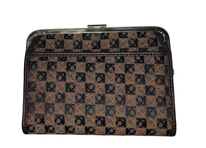 Liz Claiborne Wallet (Category: Wallets & Card holders) located in Makati City. Submitted by yerbua103 (Listing ID 1458409112, Image 3). Description: This is a vintage Liz Claiborne wallet with a brown and black monogram trifold wallet and brown leather trimming featuring a gold-tone logo plaque. Exterior shows wide kisslock for coins or keys and a flap to open for ample cards and photo compartment. First 3 pics are for references. Manage your ex