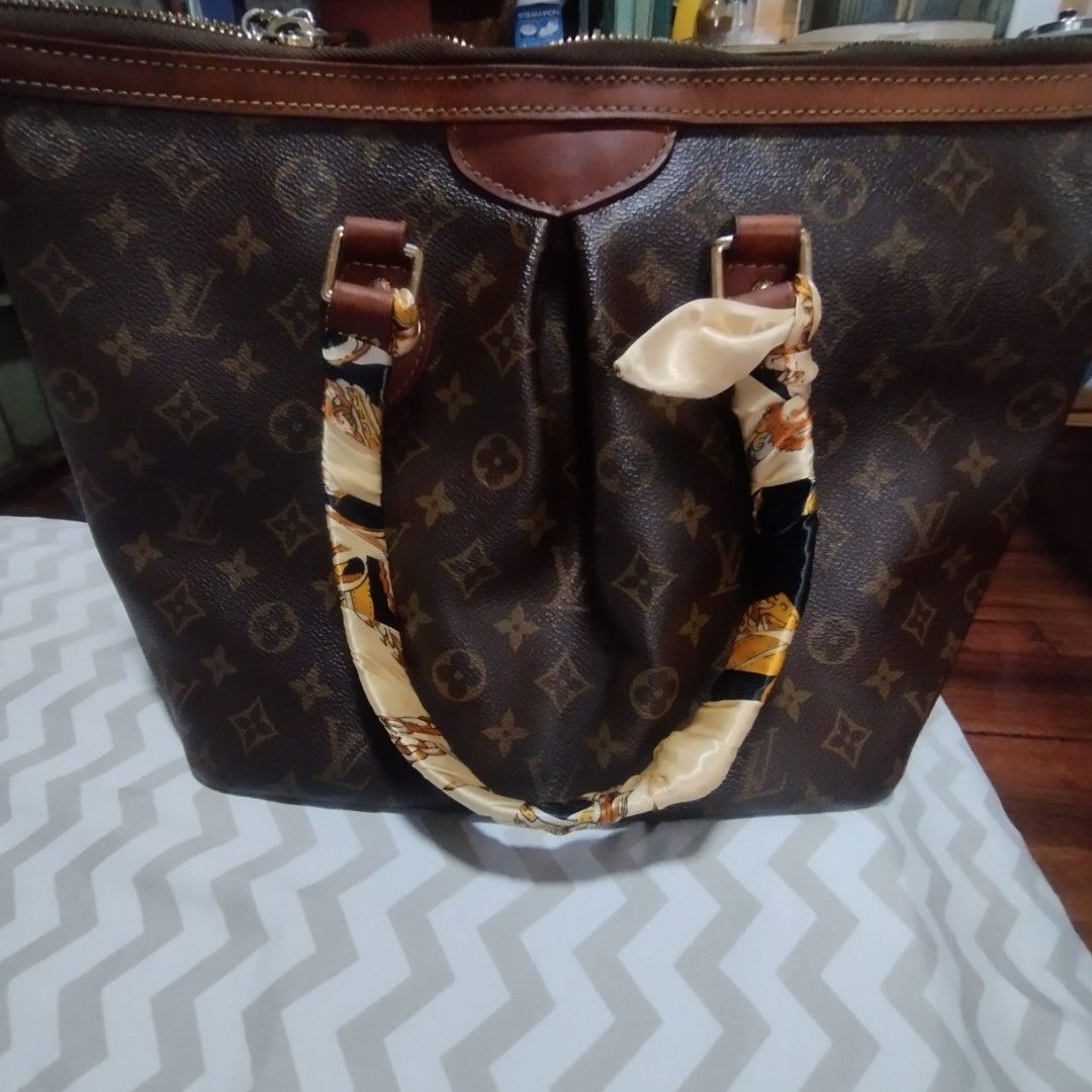 Louis Vuitton Monogram Canvas Tote Bag (Category: Luxury Bags & Wallets) located in Manila. Submitted by lene48 (Listing ID 1458422511, Image 2). Description: - Classic Louis Vuitton monogram tote - Durable leather trim - Secure zipper closure - Interior pockets for organization - Comes with a stylish scarf tied to the handle - Ideal for everyday use - Spacious interior.