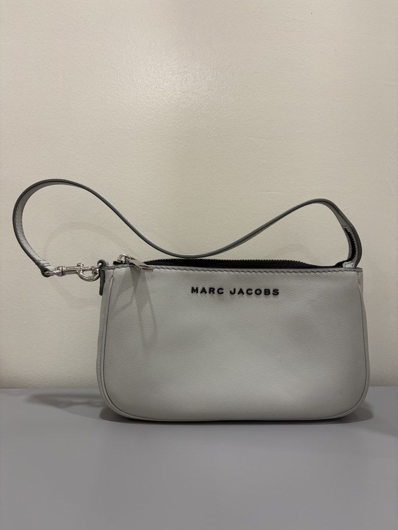 Marc Jacobs Grey Leather Mini shoulder Bag (Category: Luxury Bags & Wallets) located in Ligao. Submitted by twixiedoodle (Listing ID 1458346808, Image 1). Description: - Genuine Marc Jacobs grey leather mini bag - Secure zip closure - Interior slip pocket for organization - Unique repeating logo pattern lining - Detachable strap for versatile wear - Ideal size for carrying essentials.