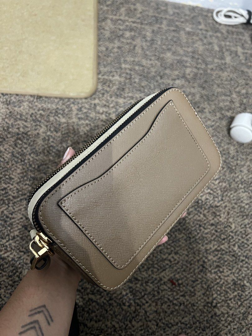 Marc Jacobs Snapshot Camera Bag Taupe Gold Hardware (Category: Luxury Bags & Wallets) located in Taguig. Submitted by aleezaaaaaa (Listing ID 1458382934, Image 3). Description: - Authentic Marc Jacobs camera bag - Color: Taupe - Signature gold hardware with double J logo - Zip closure - Front slip pocket - Side panel with Marc Jacobs logo - Detachable strap included - Ideal for everyday use RFS: declutter Slightly negotiable.