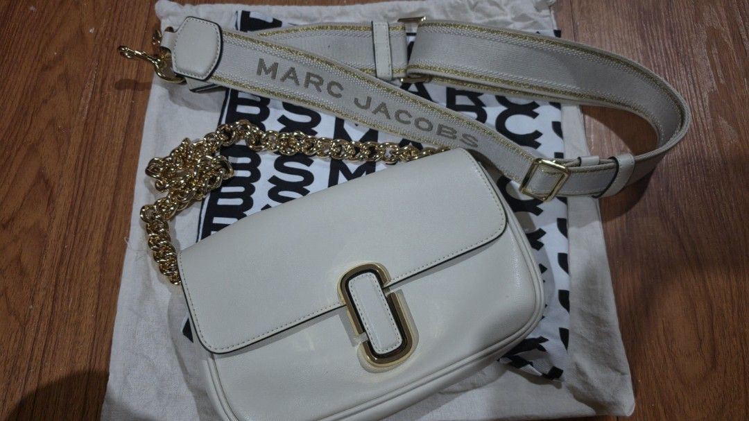 Marc Jacobs The J Marc Shoulder Bag (Category: Luxury Bags & Wallets) located in San Mateo. Submitted by lei.m (Listing ID 1458420993, Image 1). Description: - Authentic Marc Jacobs cream leather shoulder bag - Features a chic gold chain strap - Includes a detachable fabric strap with 'MARC JACOBS' lettering - Interior zip pocket and multiple compartments for organization - Comes with original dust bag - Ideal for stylish everyday wear -RFS: Too 