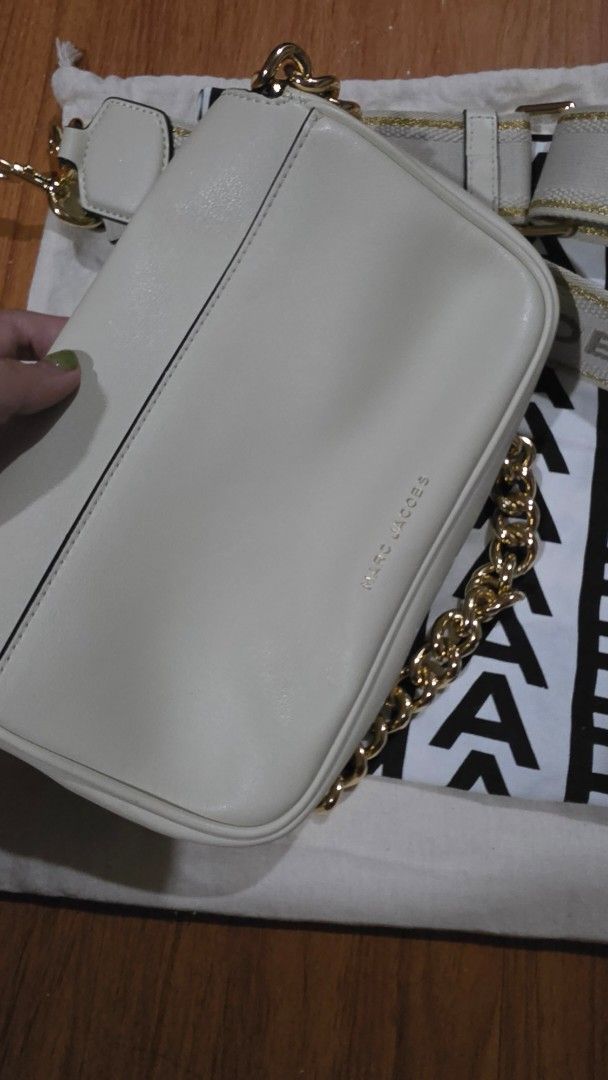 Marc Jacobs The J Marc Shoulder Bag (Category: Luxury Bags & Wallets) located in San Mateo. Submitted by lei.m (Listing ID 1458420993, Image 3). Description: - Authentic Marc Jacobs cream leather shoulder bag - Features a chic gold chain strap - Includes a detachable fabric strap with 'MARC JACOBS' lettering - Interior zip pocket and multiple compartments for organization - Comes with original dust bag - Ideal for stylish everyday wear -RFS: Too 
