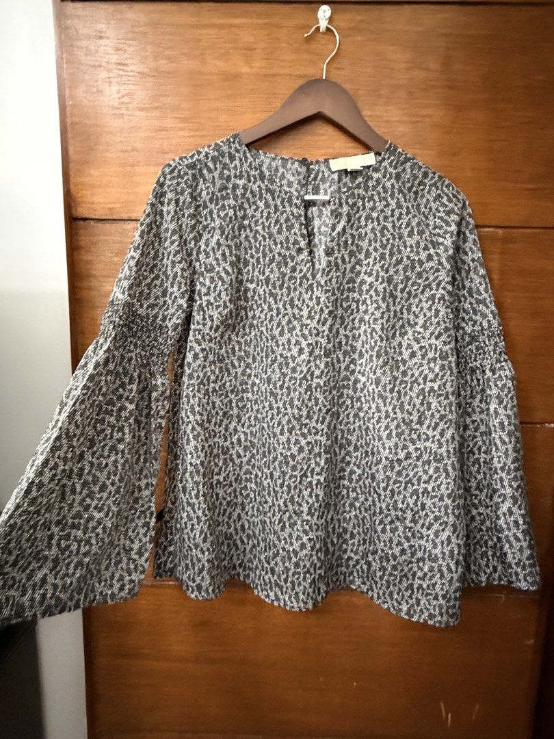 Michael Kors Black & White Printed Bell Sleeve Blouse Size M (Category: Blouses) located in Antipolo. Submitted by pinkescee (Listing ID 1458360621, Image 3). Description: - Original Michael Kors top - Black and white print - Bell sleeves with smocking detail - V-neckline with back button closure - Versatile for dressing up or down - Made in China.